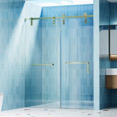 a bathroom with blue tile walls and flooring, including a walk - in shower