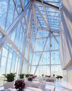 the inside of a building with tables and chairs