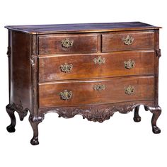 an old wooden dresser with ornate carvings on the top and bottom, against a white background