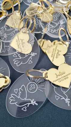 several heart shaped keychains with names and hearts engraved on them are sitting on a table