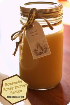 a jar filled with honey sitting on top of a wooden table next to a label