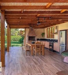 an outdoor kitchen and dining area with wood flooring