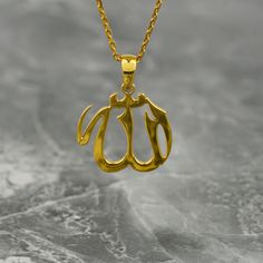 Crafted with exquisite detail and elegance, the Tiny Allah Necklace is a true masterpiece of Islamic jewelry. Made from premium sterling silver and delicately gold plated, this pendant showcases the word "Allah" in beautifully intricate Arabic script. Perfect for Muslim women, this necklace is a meaningful and thoughtful gift that symbolizes faith and devotion. Its tiny size adds a subtle touch of sophistication, making it suitable for everyday wear or special occasions. Whether worn alone or la Classic Gold Charm Necklaces With Polished Finish, Gold Charm Necklaces With Polished Finish For Gift, Gold Charm Necklace As A Gift With Polished Finish, Gold Polished Finish Charm Necklace As Gift, Gold Polished Finish Charm Necklace For Gift, Elegant Gold Engraved Charm Necklace, Elegant Engraved Gold Charm Necklace, Classic Gold Plated Name Necklace, Classic Gold Pendant Name Necklace