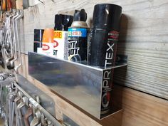 a metal shelf holding several different types of sprays