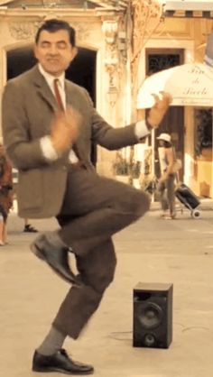 a man in a suit and tie is dancing