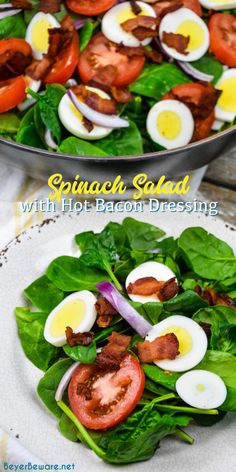 spinach salad with hard boiled eggs and bacon dressing on a white plate, ready to be eaten