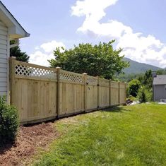 a wooden fence in front of a house