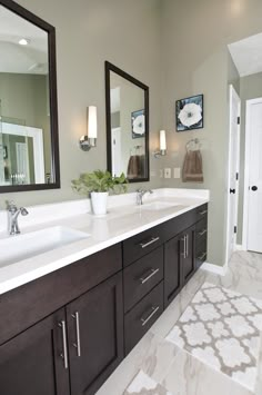 a bathroom with two sinks and mirrors in it