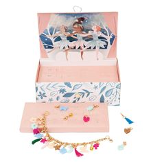 an open jewelry box with various items in it on a white background, including earrings and necklaces