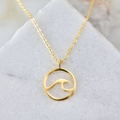 This Wave Necklace is the ideal accessory for any coastal-inspired look. Its classic but stylish design makes it the perfect piece for everyday wear. Chain: 18K gold plated over brass; measures 16" with 2" extender. Pendant: 24K gold plated 14x18mm Natural Pearl Necklace, Wave Necklace, Snake Earrings, Brass Chain, Beach Jewelry, Gorgeous Earrings, Natural Pearls, Chain Pendants, Spring Rings