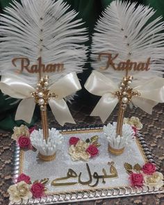 two decorated cake with white feathers and flowers