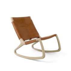 a wooden rocking chair with brown leather on the seat and back rests against a white background