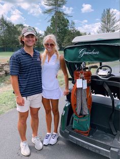 a man and woman are standing next to a golf cart with their bags on it