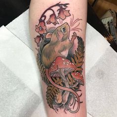 a tattoo with a mouse and mushrooms on it