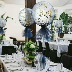 the table is set with balloons and place settings