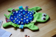 a stuffed animal laying on top of a wooden table