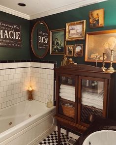 a bathroom with green walls and black and white checkered flooring on the tile