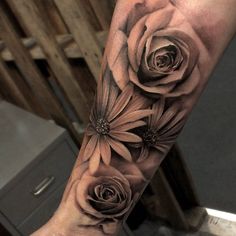 a woman's arm with flowers on it