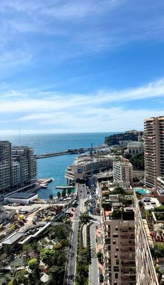 an aerial view of a city next to the ocean with tall buildings on both sides