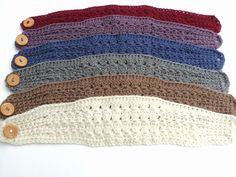 several crocheted headbands with buttons on them