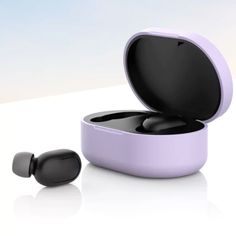 an earbud that is sitting in a box on the floor next to it