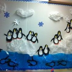 some penguins are standing in the snow and one penguin is wearing goggles on it