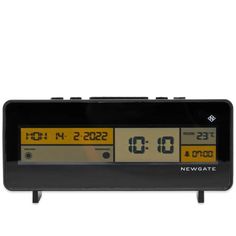 an alarm clock with the time displayed on it's display screen and two yellow numbers