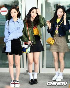 three young women standing next to each other