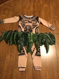 a child's bodysuit made out of leaves on the floor