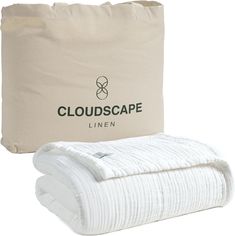 the cloudscape linen blanket is in front of a bag