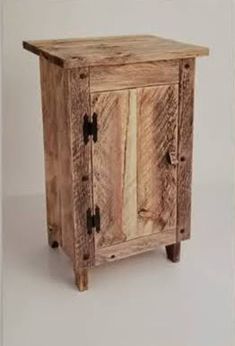 a small wooden cabinet with two doors on one side and three drawers on the other