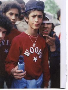 a group of young men standing next to each other in front of a crowd with one holding a water bottle