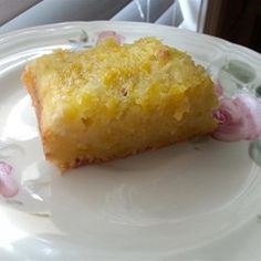 a piece of cake sitting on top of a white plate next to a glass window