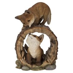 two figurines are sitting on top of each other in the shape of a circle