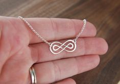 Double infinity necklace in sterling silver, sterling silver necklace, infinity symbol, eternity necklace, friendship necklace, mother's day A sterling silver double infinity symbol link that measures 0.91 x 0.39 inches (23 x 10mm) is attached to a sterling silver chain that can be any length up to 22 inches. It is secured with a sterling silver spring ring clasp. Your purchase will arrive in a jewelry box ready for gift giving or as a gift for yourself! Enter my shop here: jersey608jewelry.etsy Sterling Silver Infinity Necklace In White Gold, Sterling Silver Infinity Necklace With Adjustable Chain, Silver Infinity Necklace With Delicate Chain, Silver Infinity Jewelry, Silver Infinity Jewelry For Anniversary, Silver Infinity Necklaces For Wedding, Silver Infinity Necklace For Wedding, Dainty White Gold Infinity Jewelry, Hypoallergenic Sterling Silver Infinity Jewelry