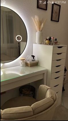 a white desk with a mirror and some drawers