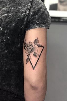 a man with a rose tattoo on his left arm and an arrow in the middle