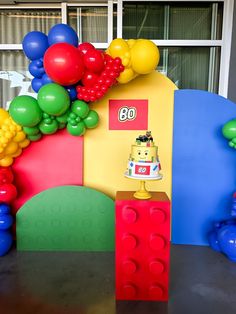 a lego themed birthday party with balloons and cake