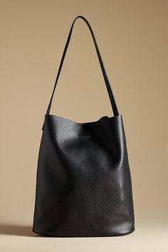 The By Anthropologie Tall Bucket Bag features a magnetic closure. It includes a removable inner pouch. The bag is made of polyurethane. Black Bucket Handbag, Bucket Tote, Bucket Bags, Leather Bucket Bag, Magnetic Closure, Bucket Bag, Leather Bag, The Bag, Anthropologie