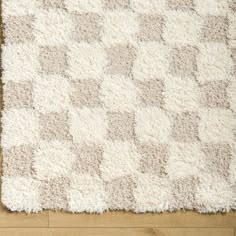 a white rug on top of a wooden floor