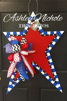 a red, white and blue star hanging on a door