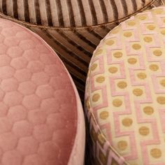 three pink and gold stools sitting next to each other