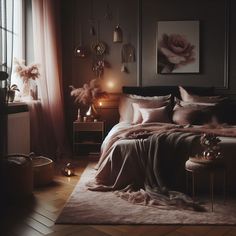 a bedroom with a large bed covered in pink blankets and pillows, candles on the floor