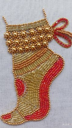 beaded christmas stocking ornament in gold and red