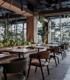 an empty restaurant with wooden tables and chairs