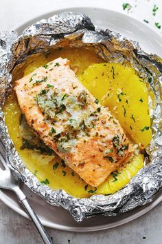 salmon and potatoes in foil on a plate