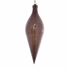 a brown vase with a bird on the top hanging from it's side in front of a white background