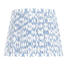 a blue and white lampshade on a white background, with an abstract pattern