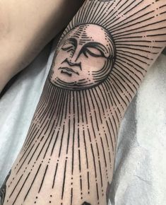 a person with a sun tattoo on their arm