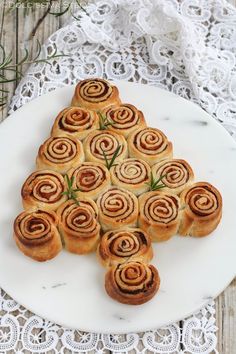 a white plate topped with pastries on top of a table